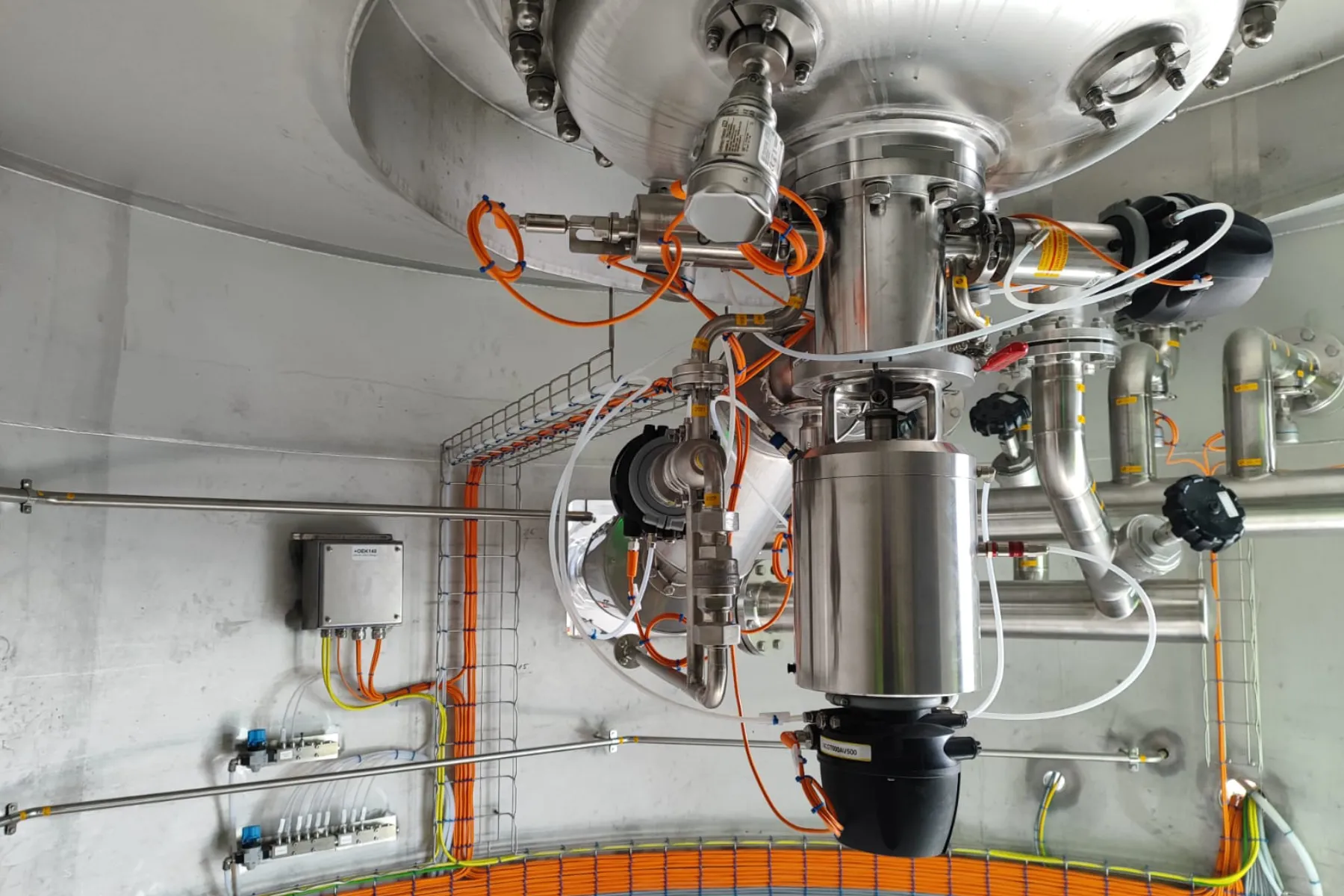Valves and fittings under a stainless steel process tank