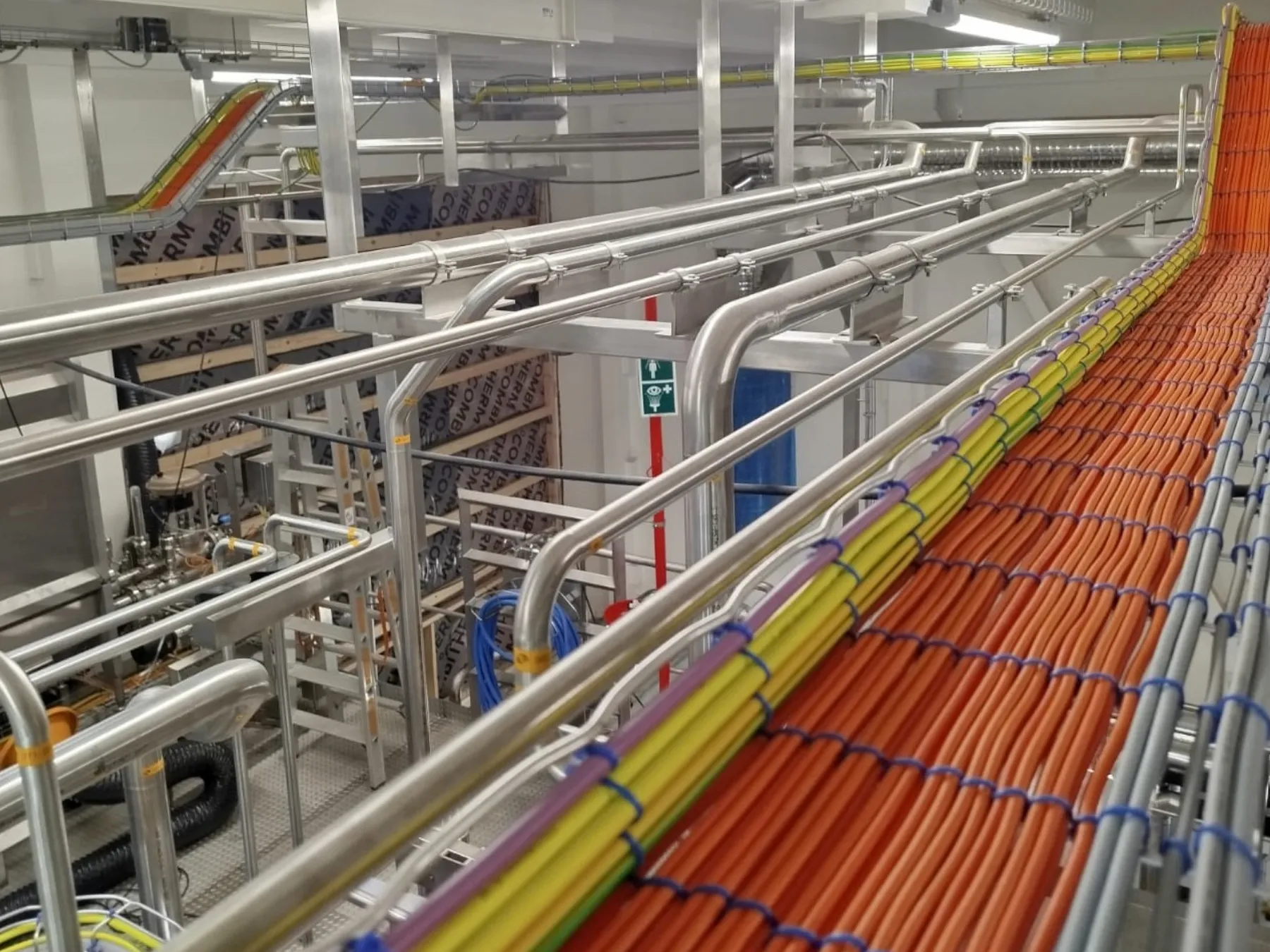 Cables on a cable route along pipework in a pharmaceutical plant, Bionorica, Neumarkt